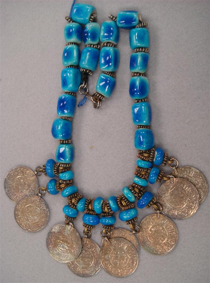 Appraisal: Necklace featuring bright blue glass beads enhanced hanging coins Estimate