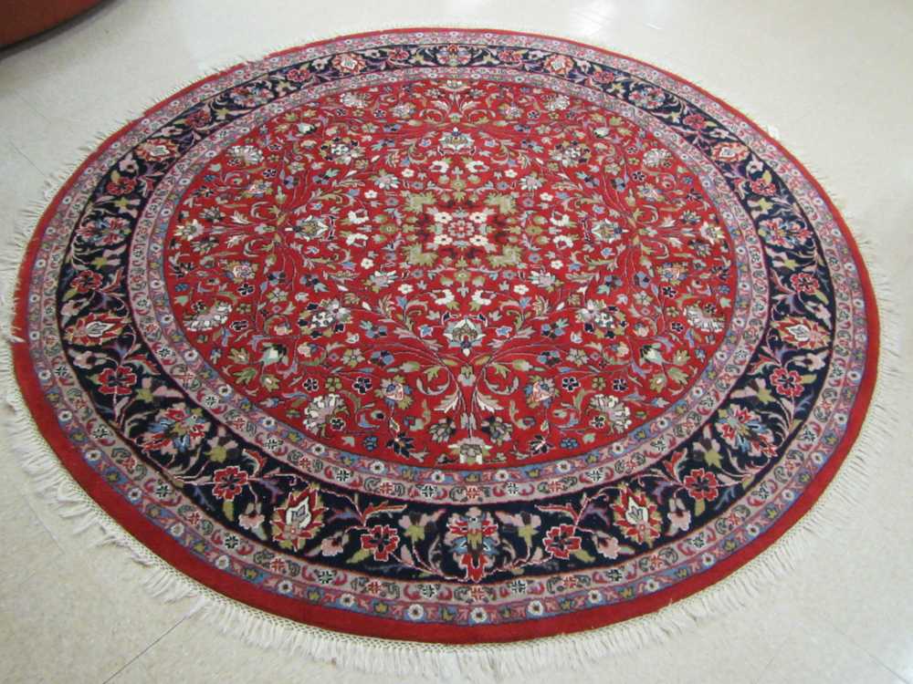 Appraisal: A ROUND ORIENTAL CARPET Indo-Persian floral and central rosette medallion