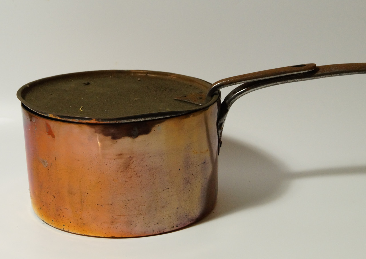 Appraisal: A Victorian copper saucepan and cover with iron handles cm