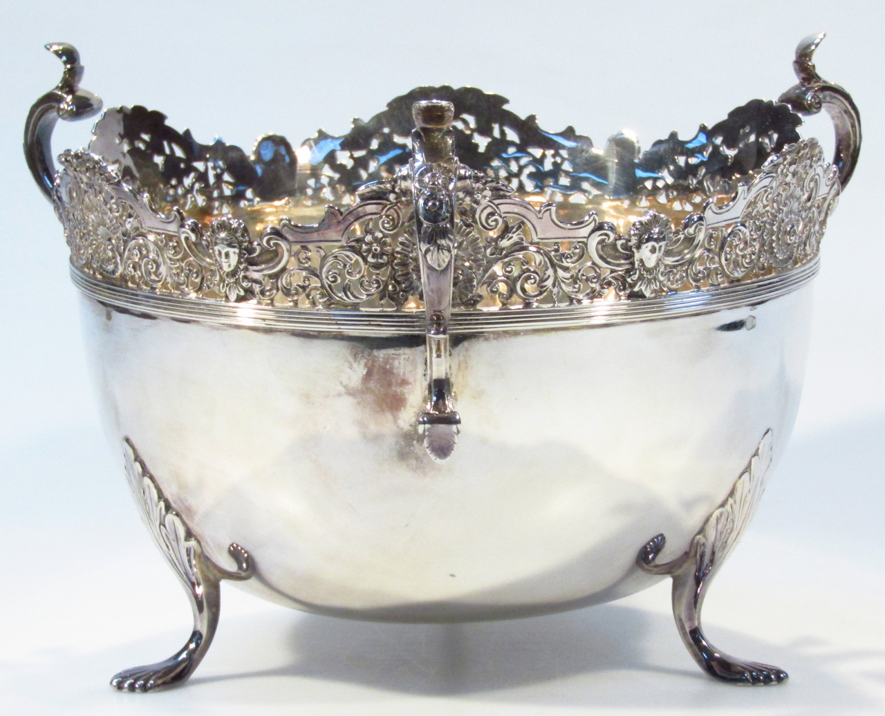 Appraisal: An Edwardian silver bowl by Walker Hall with triple scroll