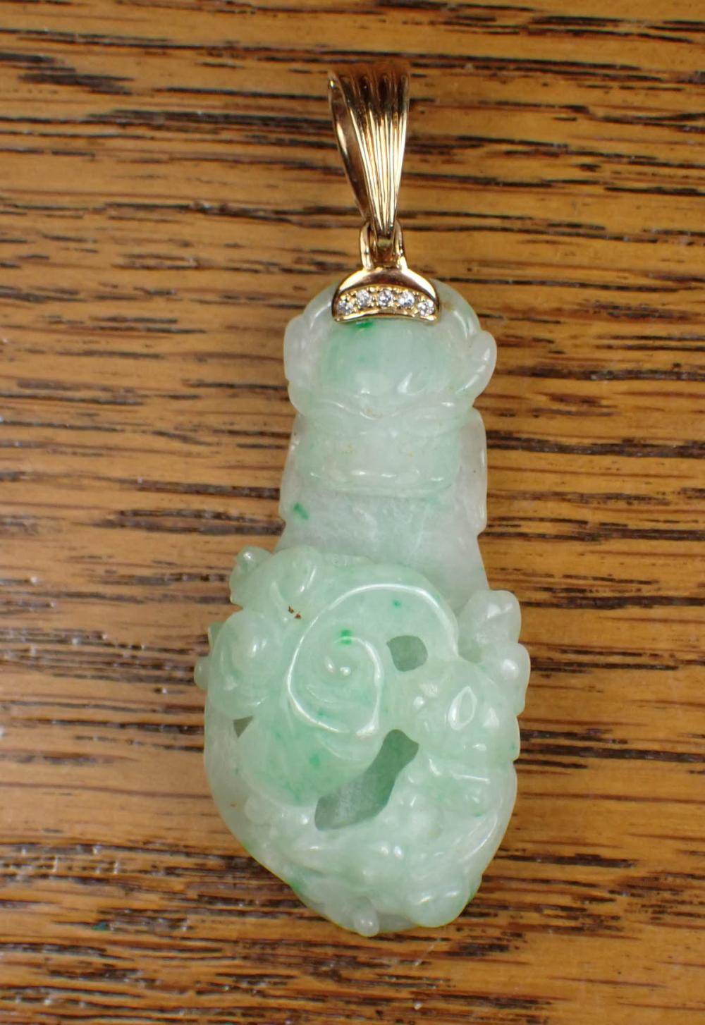 Appraisal: JADE DIAMOND AND FOURTEEN KARAT GOLD PENDANT with a green