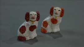 Appraisal: A pair of Staffordshire figures of spaniels