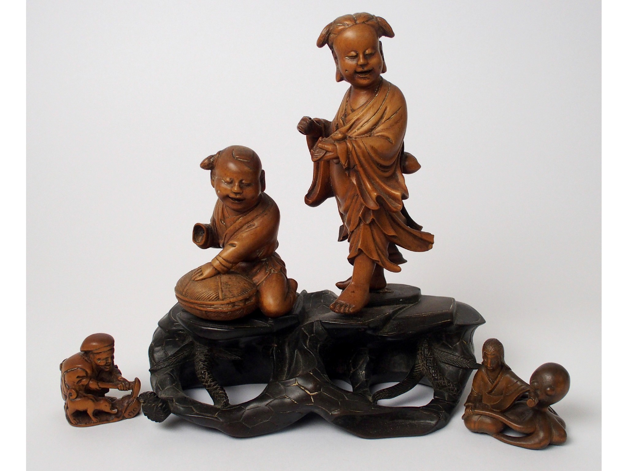 Appraisal: A Japanese carved wood figure of a seated woman and