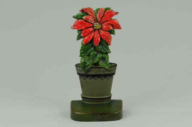 Appraisal: POINSETTIA DOORSTOP cJo Judd solo poinsettia surrounded by leaves in