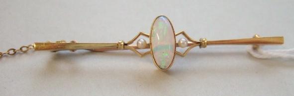 Appraisal: A gold bar brooch mounted with the oval opal at