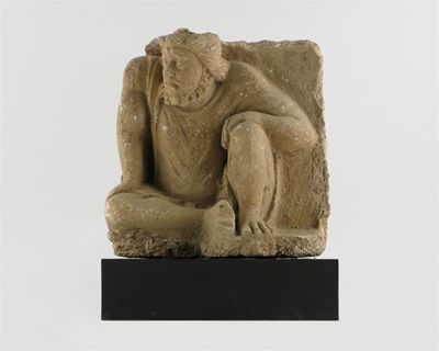 Appraisal: A Gandh ra stucco figure of Atlas seated with his