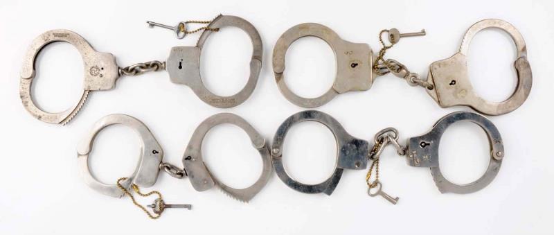 Appraisal: Lot Of Handcuffs First handcuff is Japanese Swing through Second