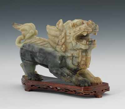 Appraisal: Carved Jade Lion Snarling jade lion with carved wooden stand