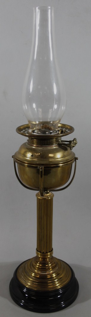 Appraisal: An early Edwardian brass oil lamp with clear Cera chimney