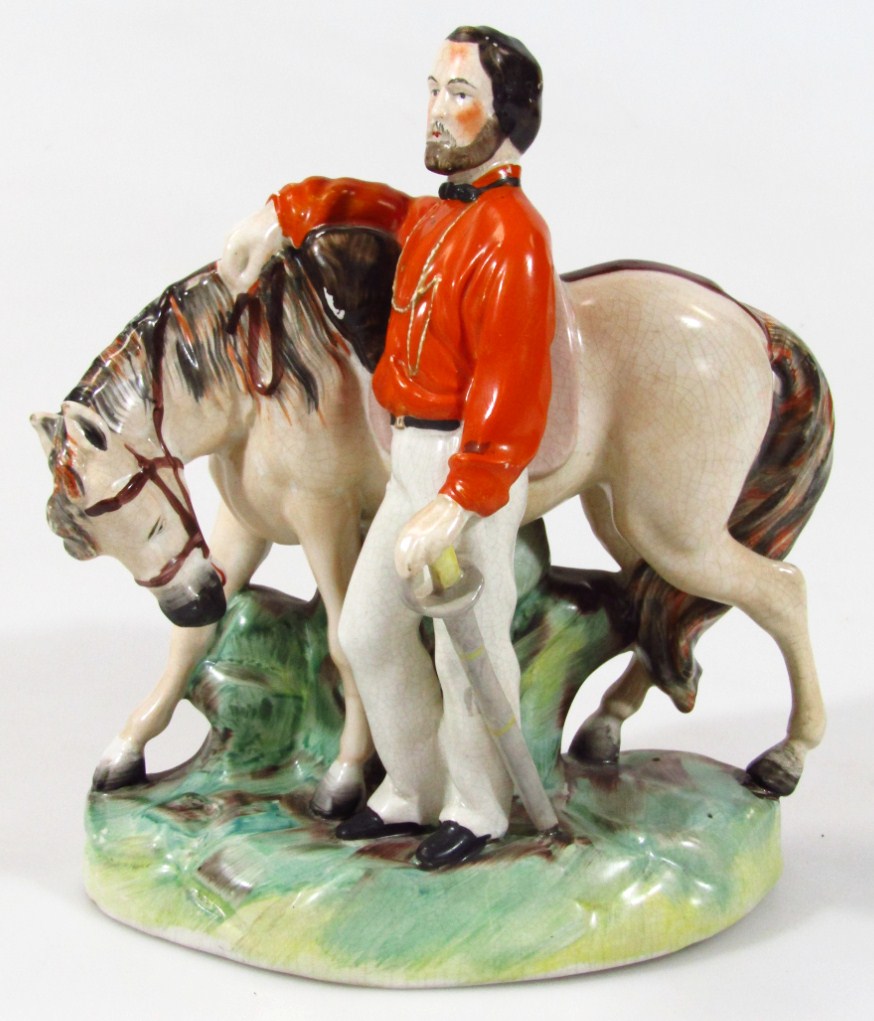 Appraisal: A thC Staffordshire figure of Garibaldi standing aside his horse