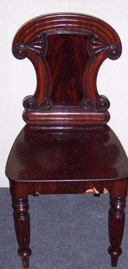 Appraisal: An early Victorian mahogany hall chair with shaped cartouche back