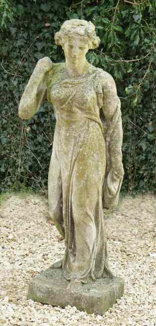 Appraisal: AN OLD WEATHERED COMPOSITION GARDEN STATUE in the form of