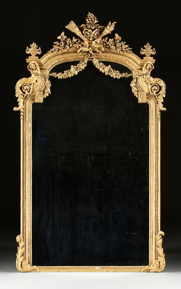 Appraisal: A LOUIS XVI REVIVAL PARCEL-GILT AND ORNATELY CARVED MANTLE MIRROR