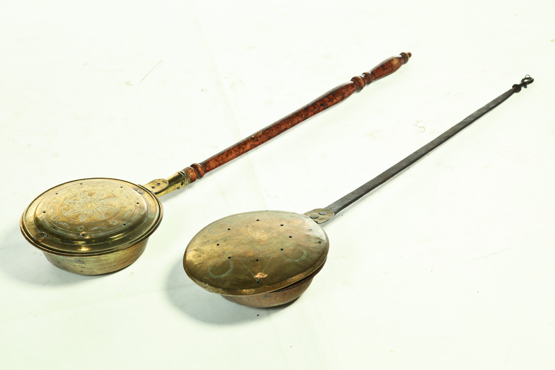 Appraisal: TWO AMERICAN BEDWARMERS Nineteenth century Engraved brass pans Turned wooden