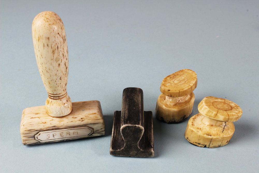 Appraisal: Four Whale Ivory and Whalebone Whale Stamps Four Whale Ivory