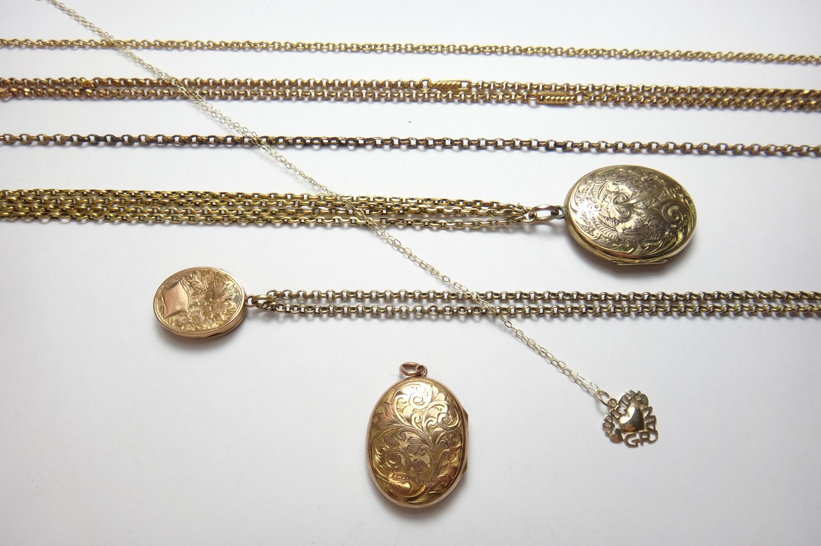 Appraisal: Three oval pendant lockets each with engraved decoration five various