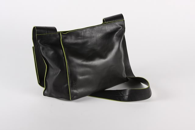 Appraisal: DKNY black leather asymmetric handbag with green trim cloth storage