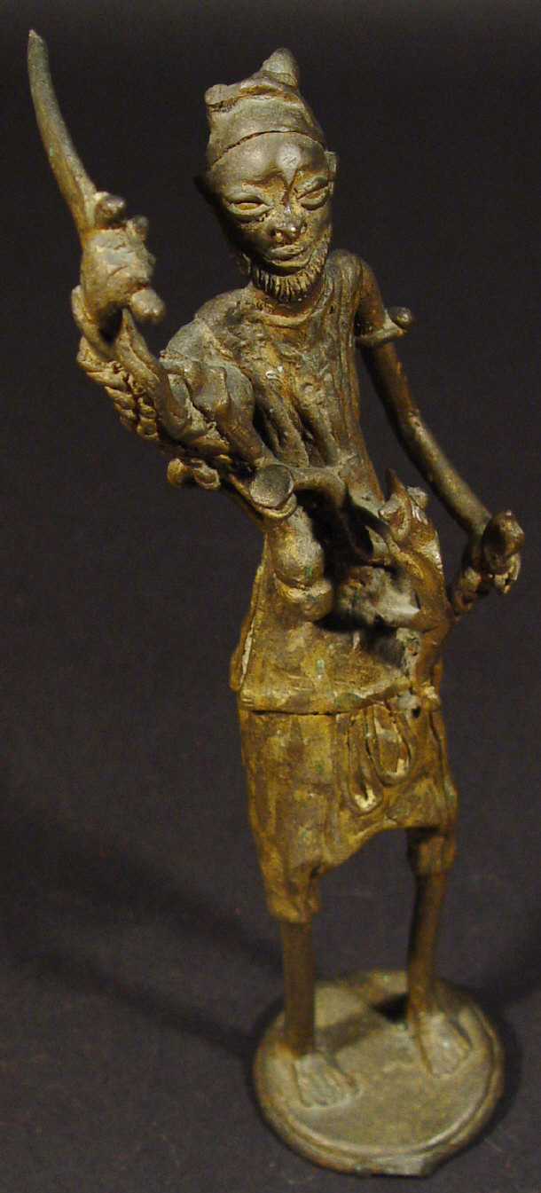 Appraisal: Metal tribal figure of a warrior clutching a kukri knife