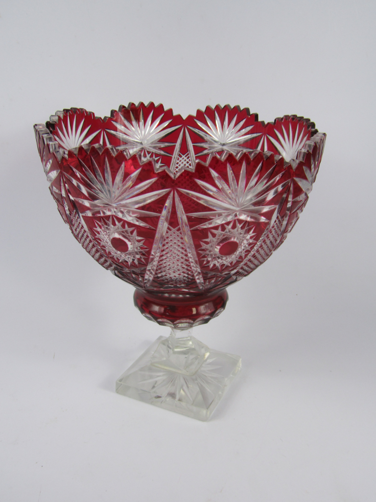 Appraisal: A Continental ruby flashed glass fruit bowl raised on a