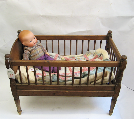 Appraisal: GERMAN BISQUE HEAD DOLLS A BASSINET A CRIB pieces The