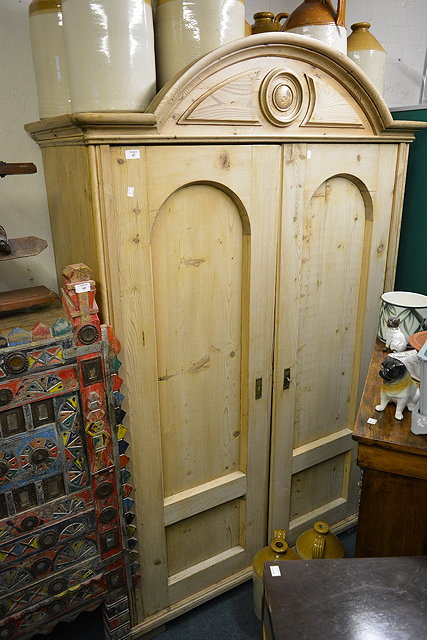 Appraisal: A continental pine wardrobewith arched cornice cm x cm high