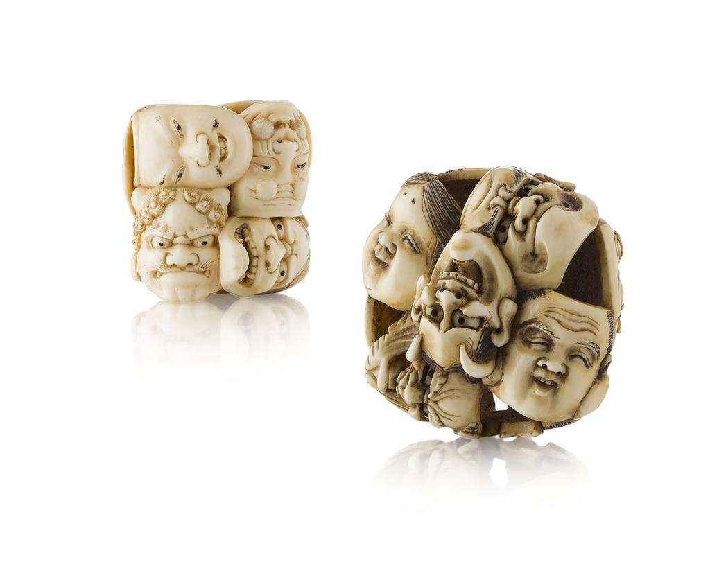 Appraisal: YTWO CARVED IVORY 'MASKS' NETSUKE TH CENTURY the fist a