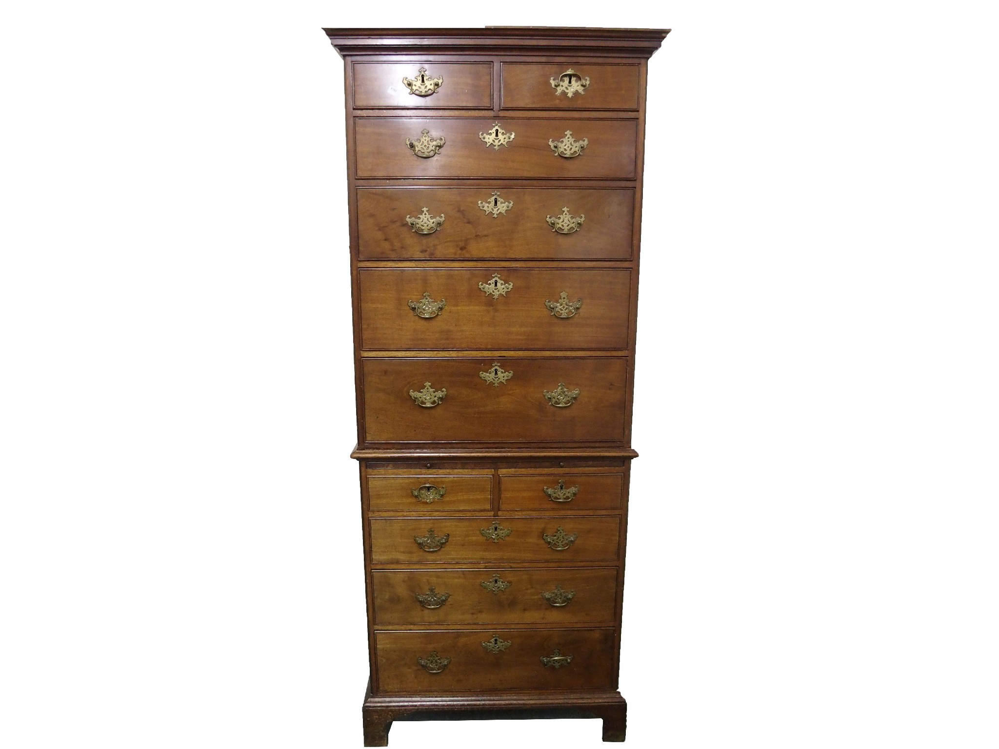 Appraisal: A Georgian mahogany chest on chestthe overhanging cornice above two