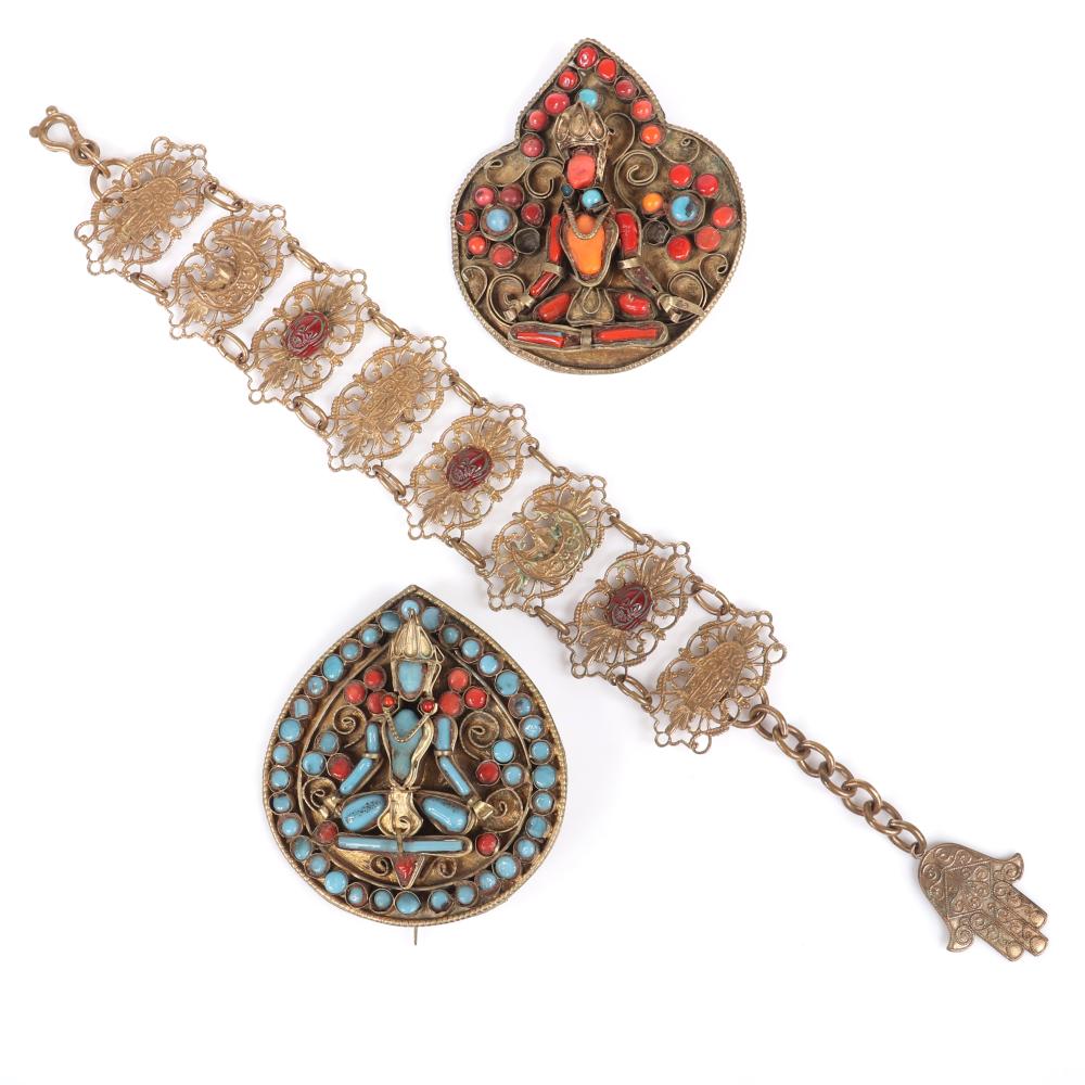 Appraisal: TIBETAN PAIR OF DIMENSIONAL FIGURAL BROOCHES WITH TURUQOISE AND RED