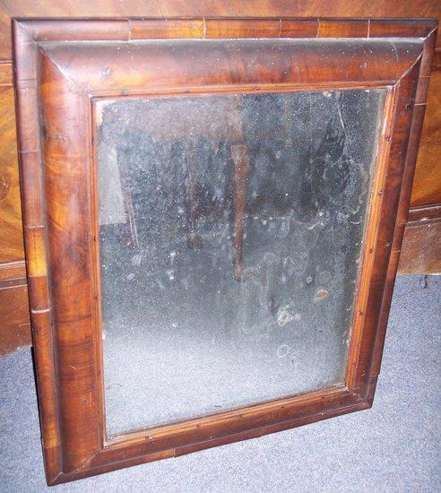 Appraisal: A William and Mary rectangular walnut wall mirror the cushion