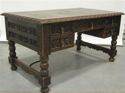 Appraisal: Renaissance style carved walnut desk carved molded top over central