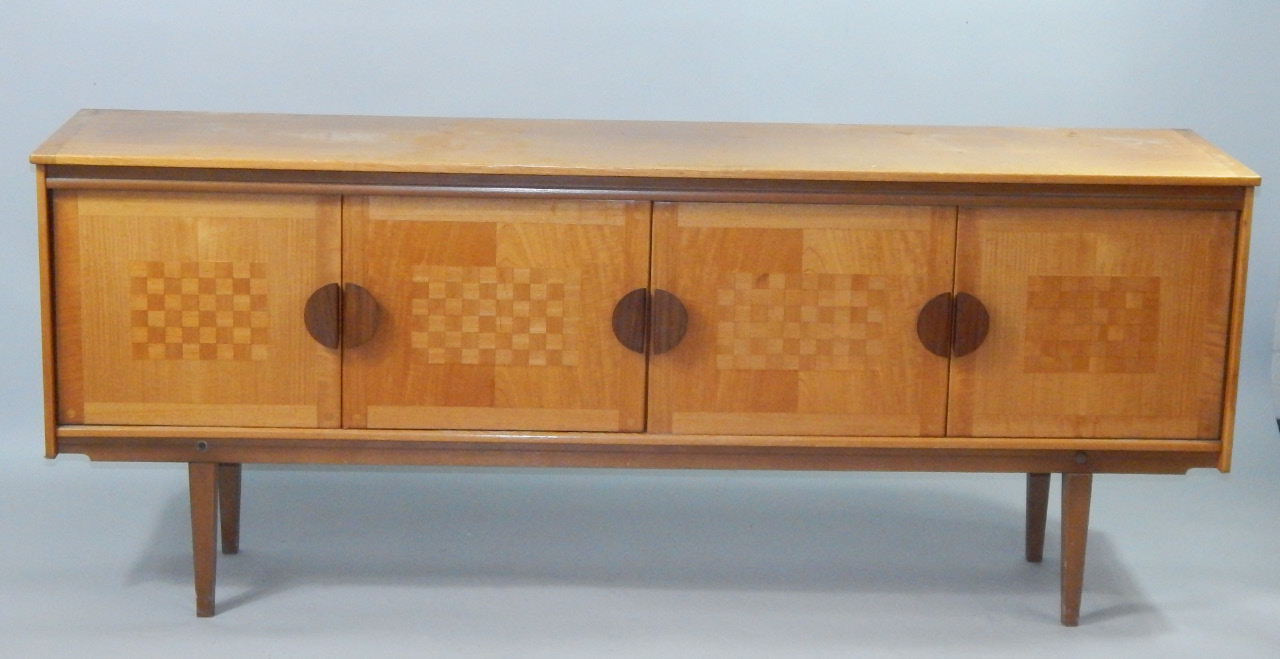 Appraisal: A teak sideboard 's the front with a pair of