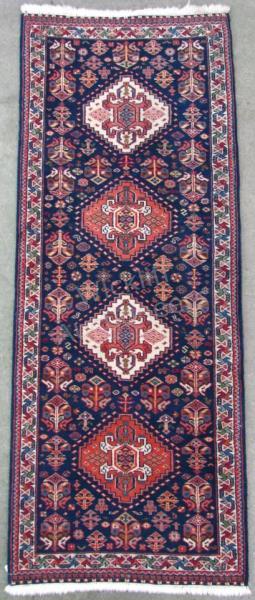 Appraisal: A handmade Oriental runner traditional Persian design navy field four