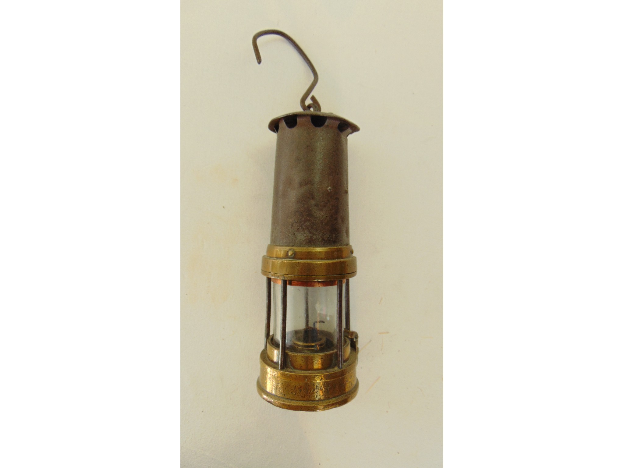 Appraisal: A steel miner's lamp with studded brass mounts