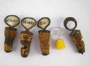 Appraisal: Bottle stoppers A set of three labelled m o p