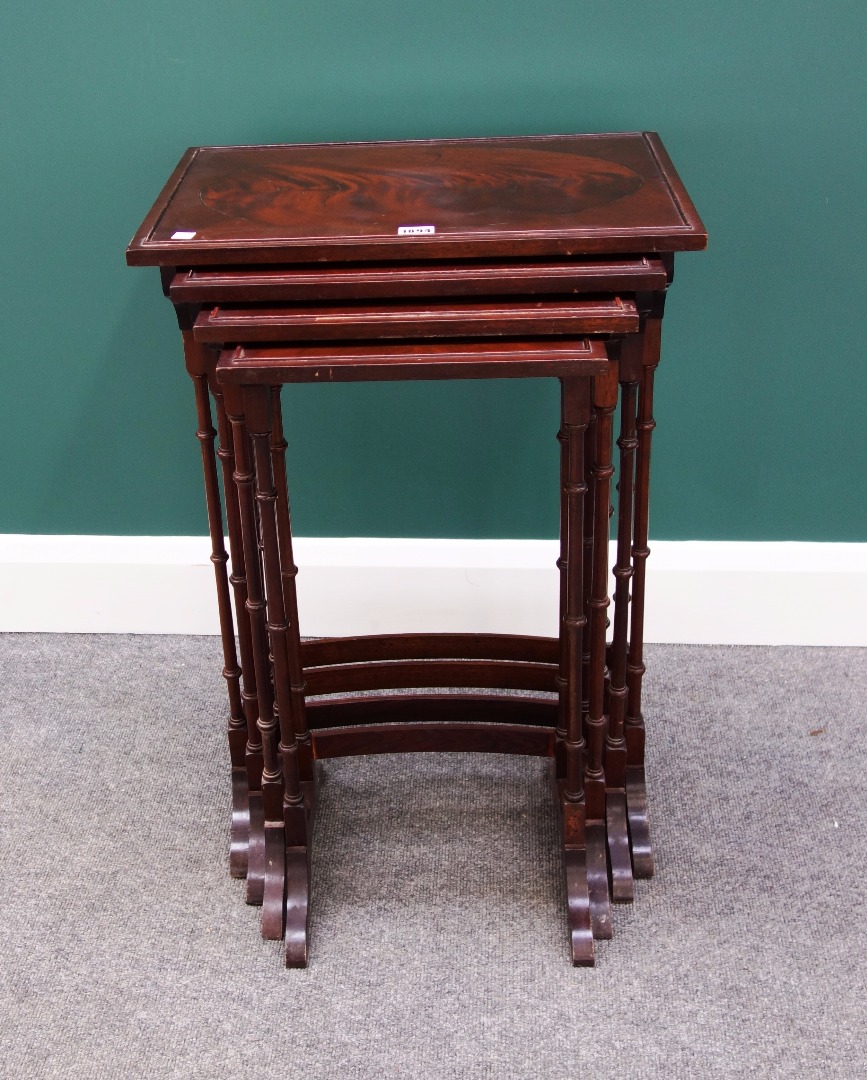 Appraisal: A nest of four mahogany occasional tables on turned supports