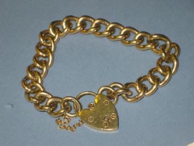 Appraisal: A CT GOLD BRACELET of flattened curb link with heart