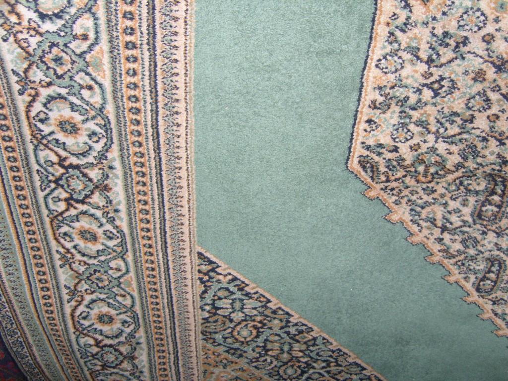 Appraisal: A Persian style wool carpet with green ground field and