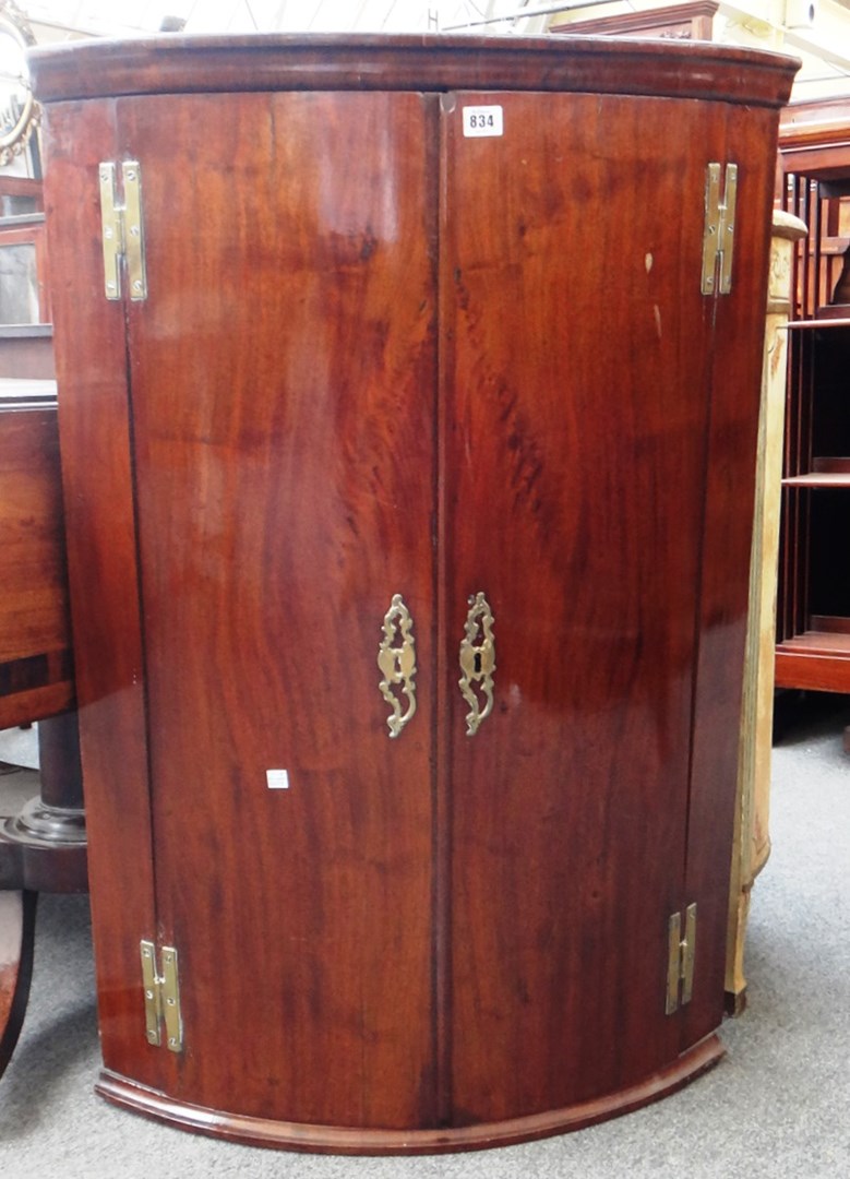 Appraisal: An th century mahogany bowfront hanging two door cupboard cm