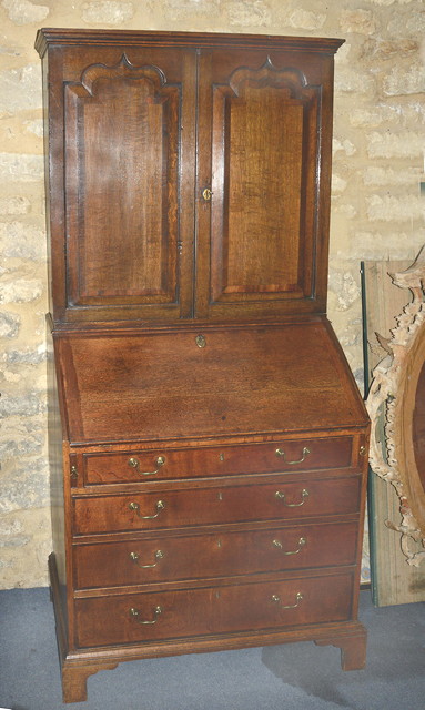 Appraisal: A GEORGE III OAK BUREAU CABINET constructed in two sections