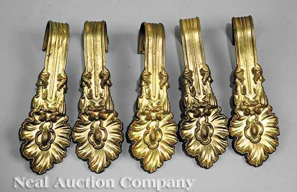 Appraisal: Ten Victorian Pressed Brass Tiebacks th c each terminating in