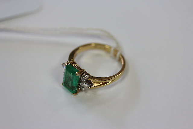 Appraisal: A RECTANGULAR EMERALD TYPE STONE SET RING with diamond like