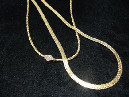 Appraisal: Two karat yellow gold neck chains Including a twenty inch