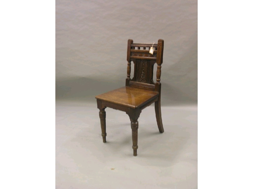 Appraisal: An Arts and Crafts oak hall chair with carved detail