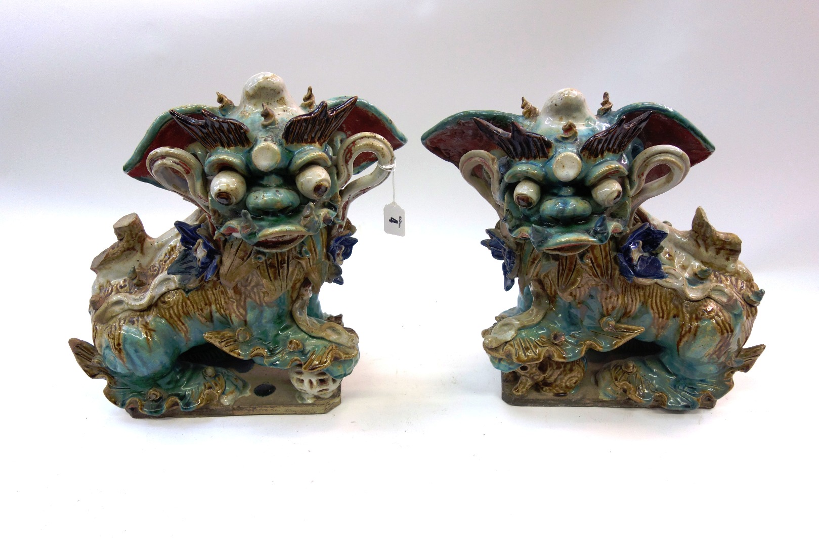 Appraisal: A pair of Chinese glazed pottery figures of Buddhist lions