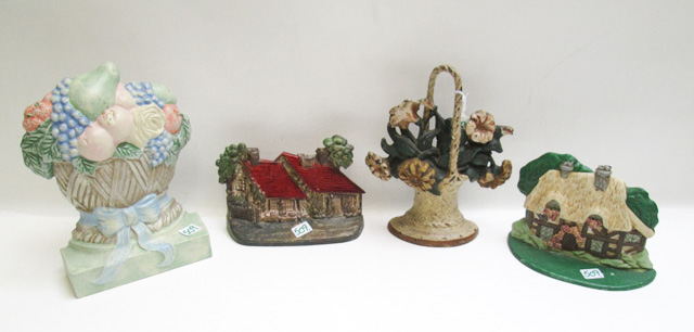 Appraisal: FOUR CAST IRON DOOR STOPS the first two cottage theme