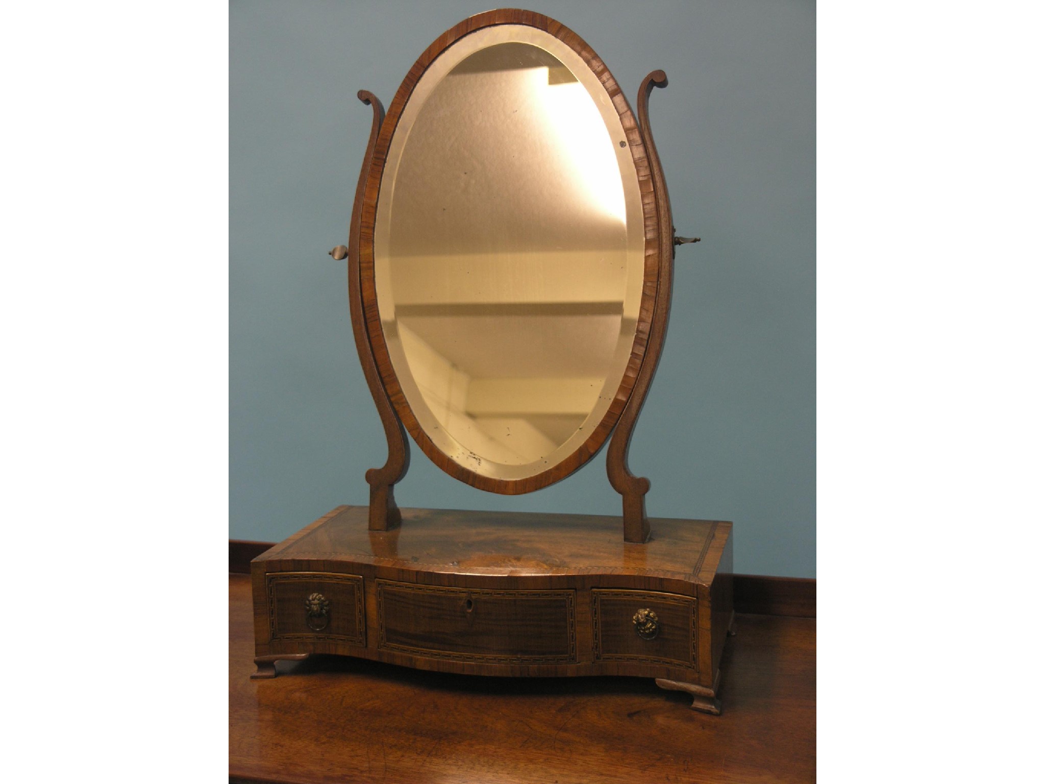 Appraisal: A Victorian mahogany toilet mirror oval bevelled plate adjustable on