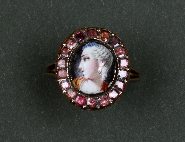 Appraisal: A GEORGIAN GARNET AND ENAMEL DRESS RING central panel depicting