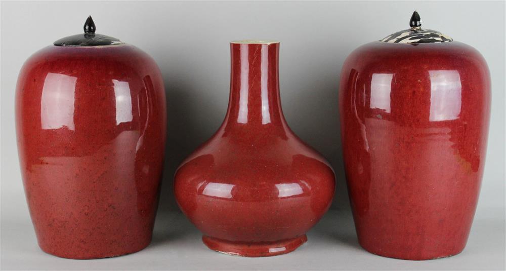 Appraisal: PAIR OF CHINESE SANG-DE-BOEUF-GLAZED OVOID JARS AND COVERS together with