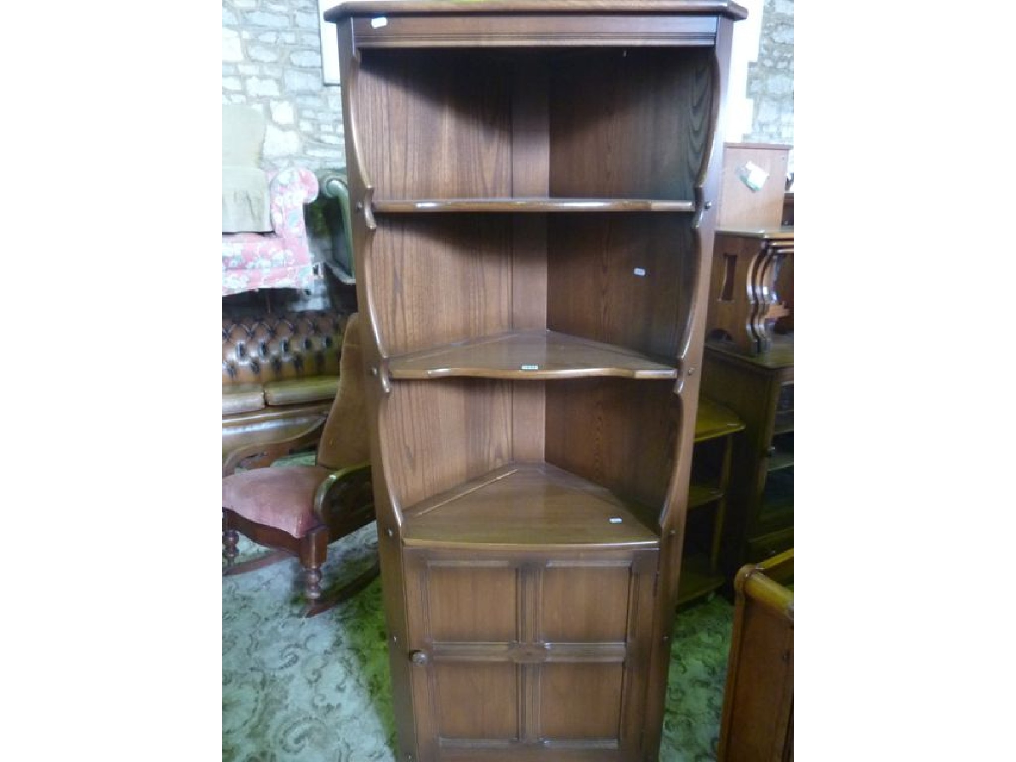 Appraisal: A contemporary Ercol medium elm Golden Dawn freestanding corner cupboard