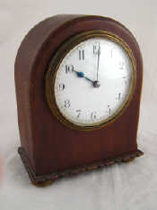 Appraisal: A round topped mahogany mantel clock c with domed glass